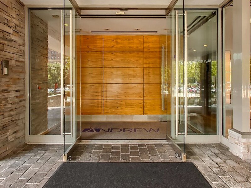 a glass door with a black mat