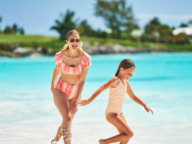 Mom and daughter playing at the beach at Grand Isle Resort