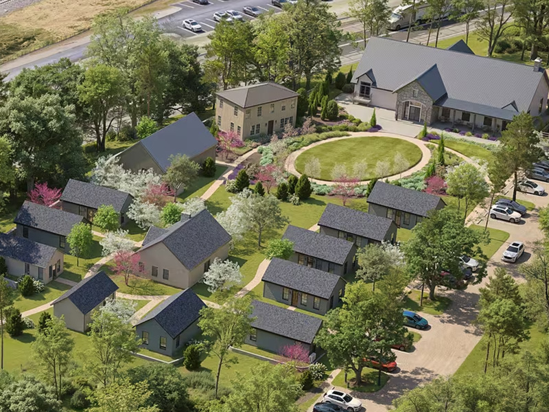 a group of houses with trees and a road