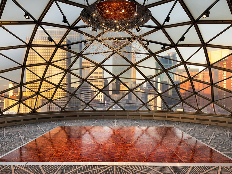 a large room with a large glass ceiling and a large city view