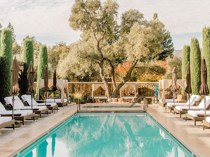 a pool with chairs and umbrellas